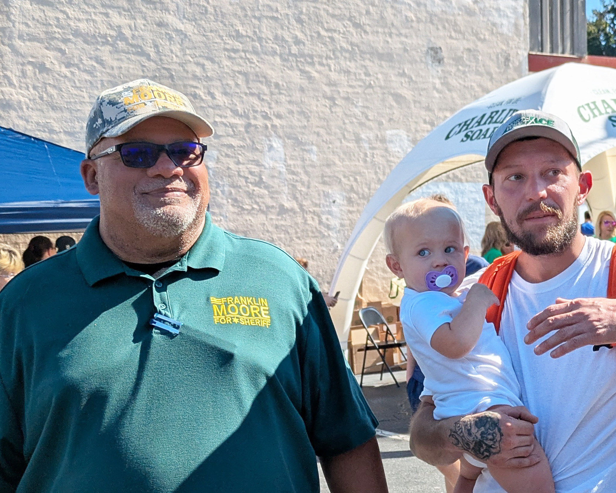 Frank meeting a voter with their baby at the festival